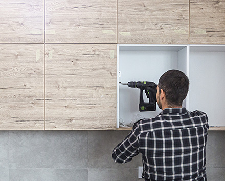 Man Doing a Kitchen Cabinet Refacing Job